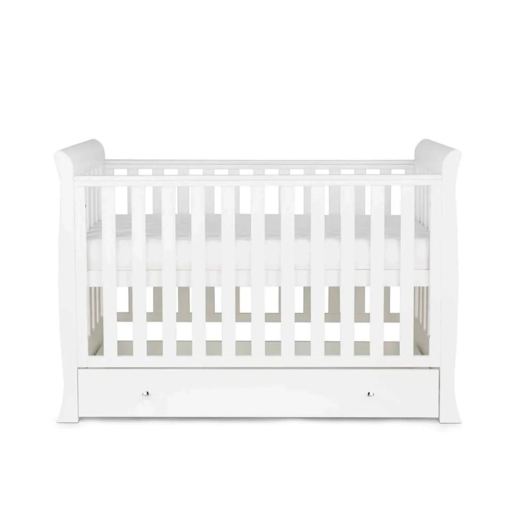 White mini cot bed with vertical slat rails, open interior, and front drawer