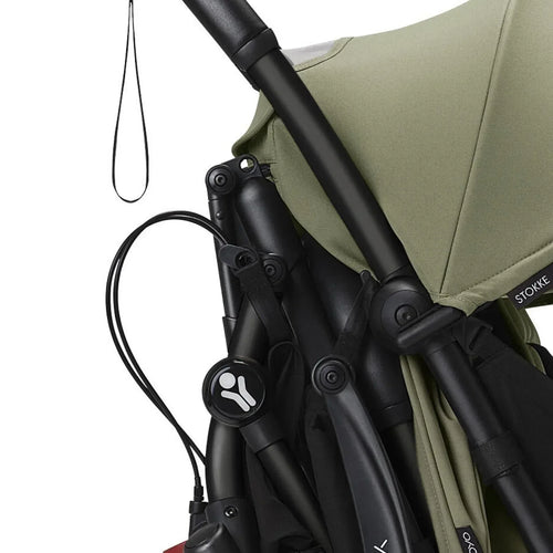 Stroller frame with black wheels and olive seat canopy