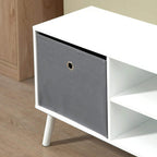 Grey fabric drawer front with metal ring pull on a white TV cabinet frame