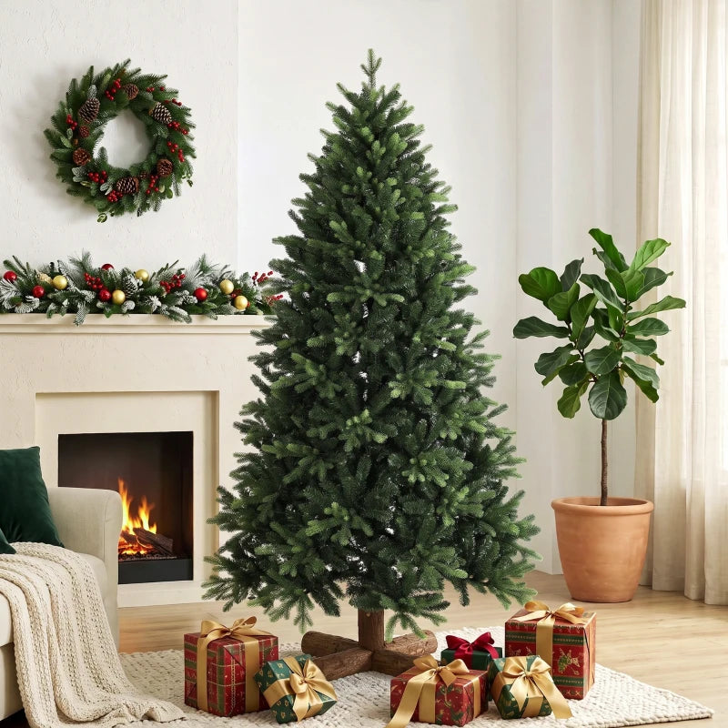 Green artificial Christmas tree with gifts beneath on wooden stand by fireplace