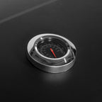 Close-up of black grill lid thermometer with temperature gauge