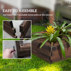 Brown wooden raised planter being assembled with metal corner poles, open-top frame.