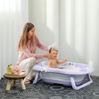 Purple foldable baby bathtub with cushion pad and support legs on an indoor floor