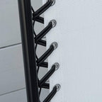 Close-up of cream mesh fabric secured to black folding chair frame with strap ties