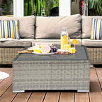 Square wicker rattan coffee table with grey glass top, light grey frame and woven sides