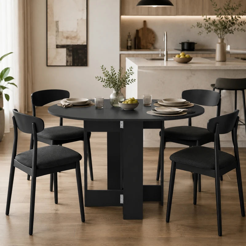 Black round drop-leaf dining table with opened leaves and four chairs around it