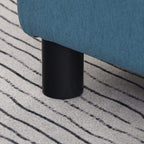 Black plastic leg of a blue linen cube ottoman footstool