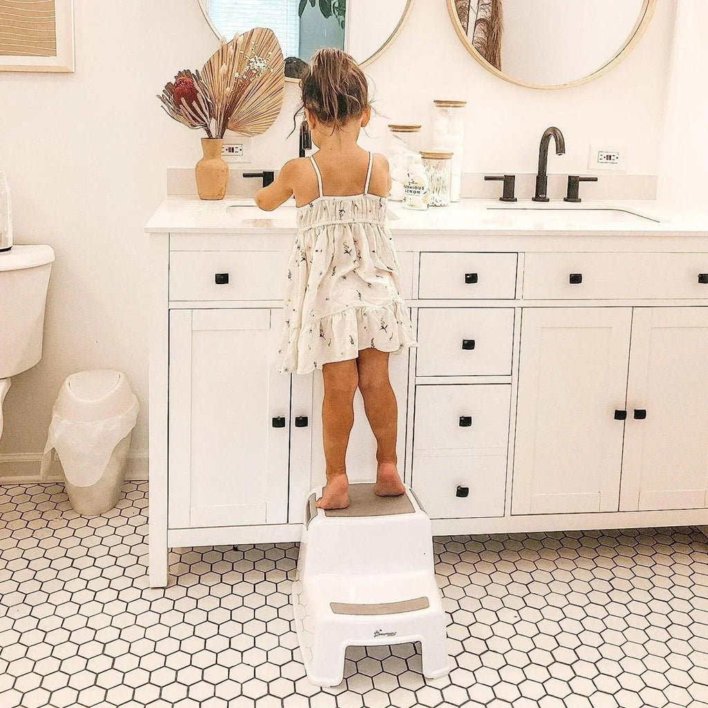 White two-step step stool with textured top platform and open side frame