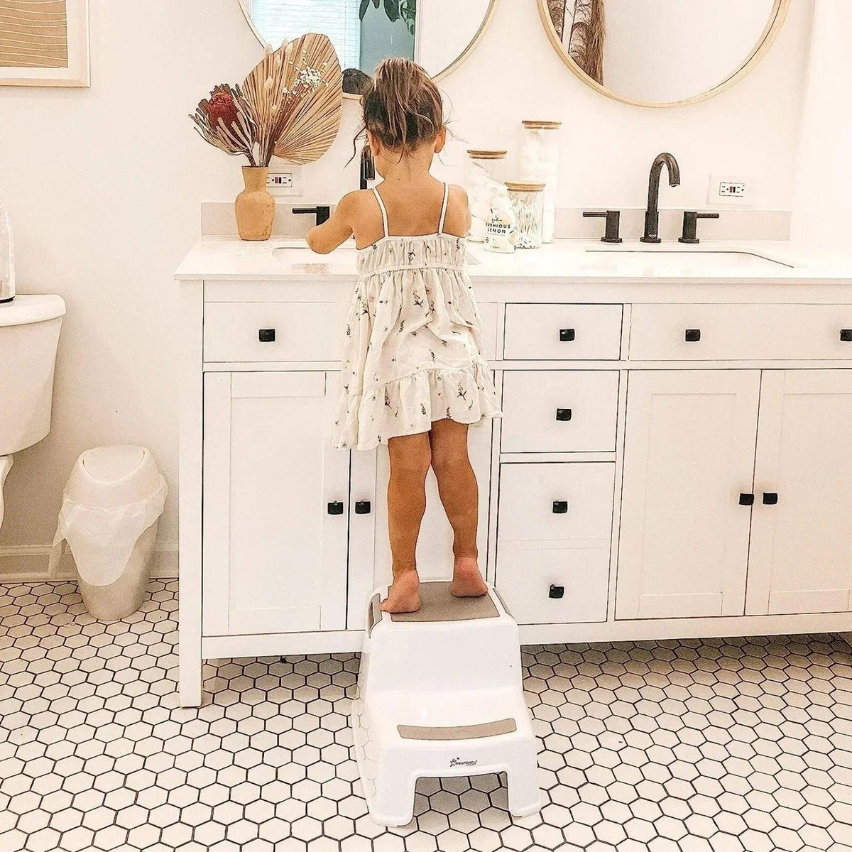 White two-step step stool with textured top platform and open side frame