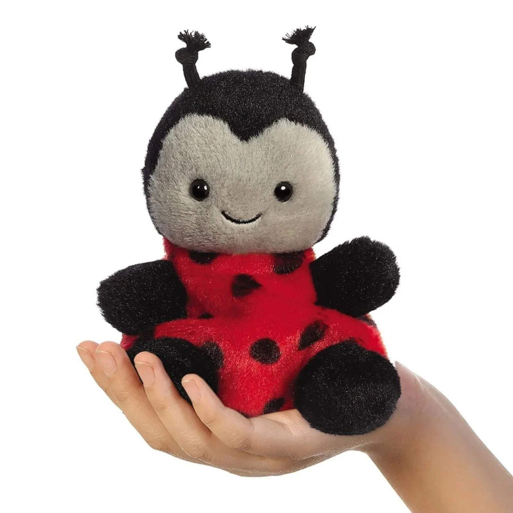 Ladybird soft toy plush held in a hand, red body with black spots and antennae