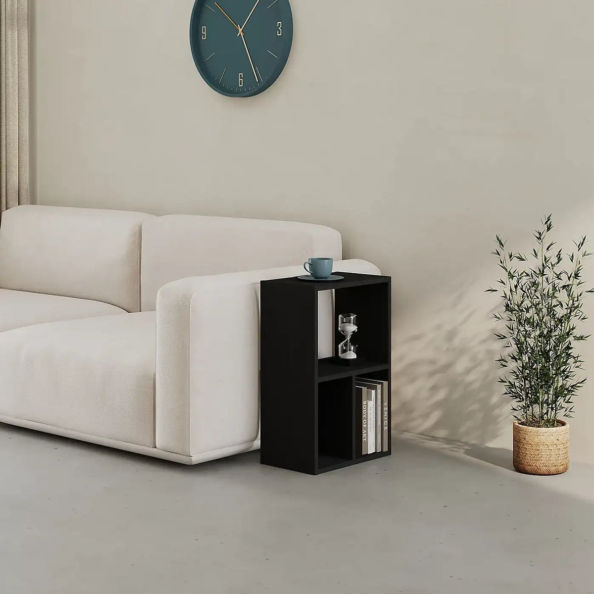 Black low standing modular bookcase with open cubby shelves and top surface