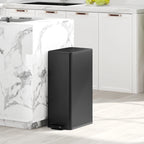 Black slim kitchen pedal bin beside a countertop with lid closed