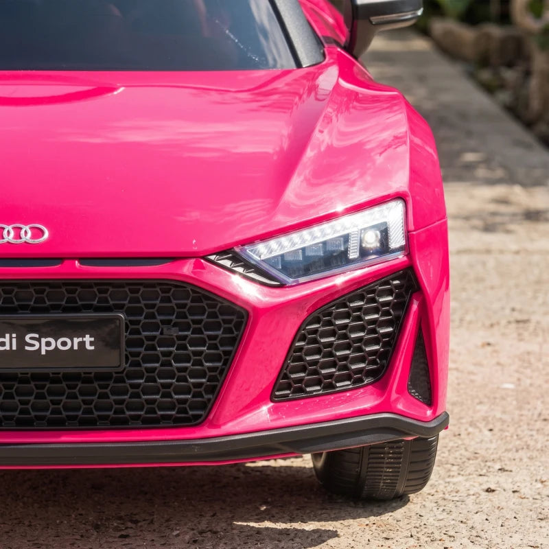 Close-up of pink front headlight and grille on a kids electric ride-on car