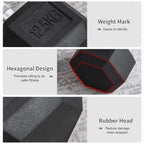 Black rubber hex dumbbell head close-up with embossed weight and textured surface