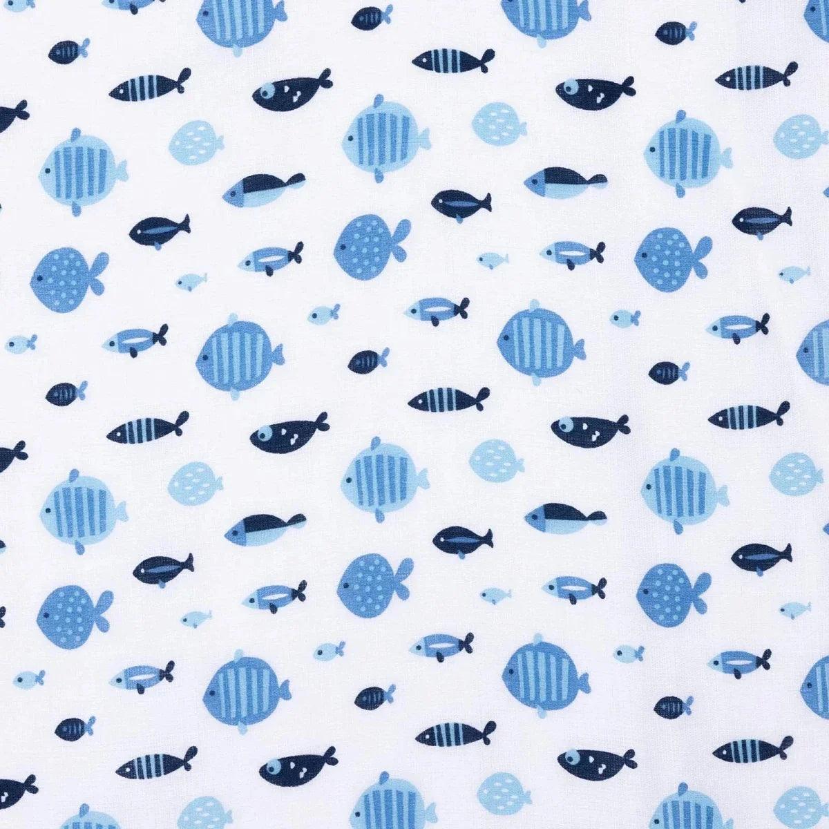 Close-up of blue muslin baby blanket fabric with fish and turtle pattern