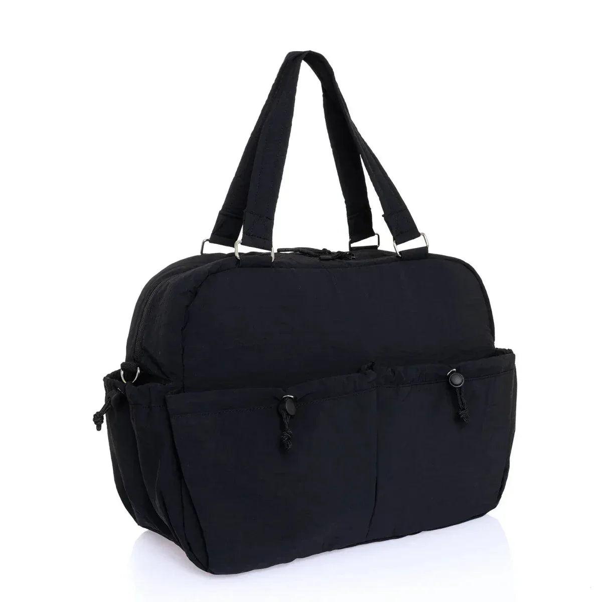 Quilted black shoulder bag with dual top handles and front zip pockets