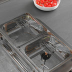 Close-up of stainless 4-tray electric food warmer with clear inset warming pans
