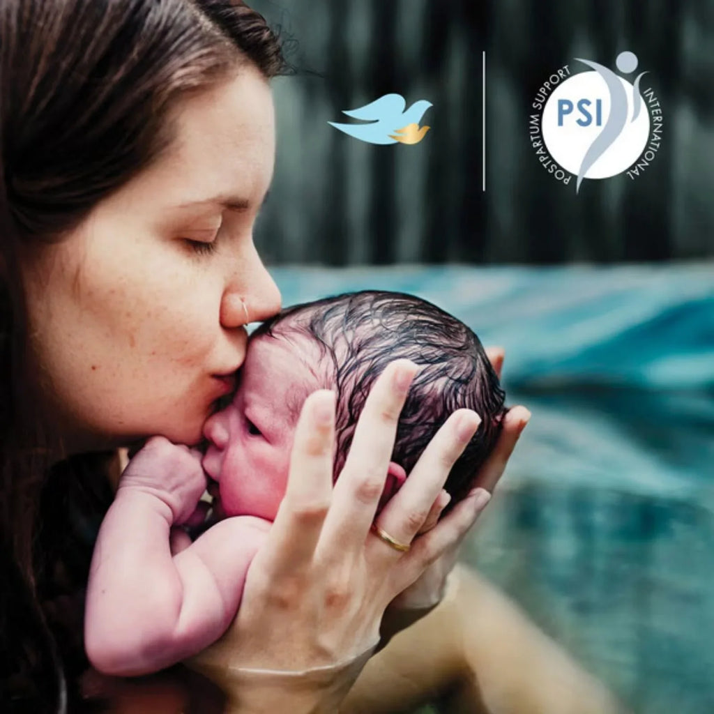 Mother holding newborn while bathing, for gentle sensitive-skin care wash