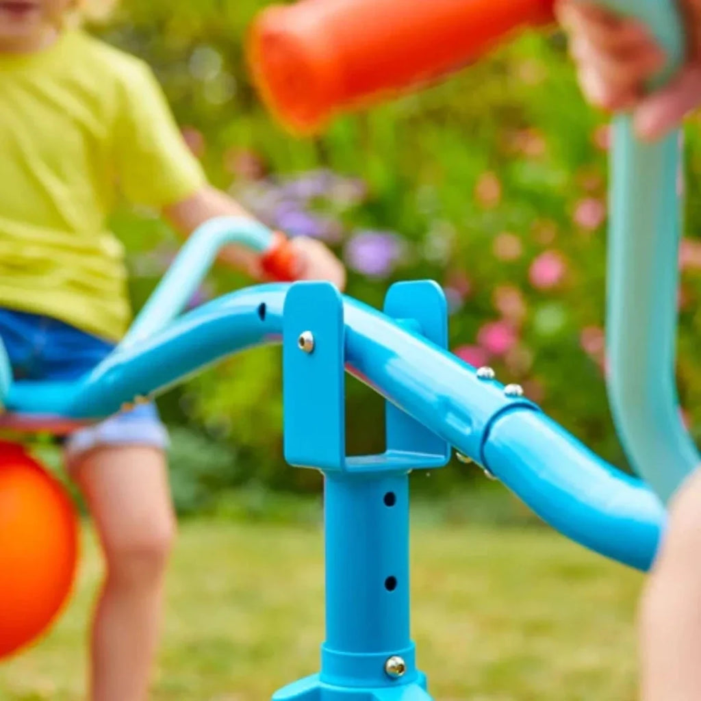 Blue hop seesaw frame with orange ball seat and green grip handles