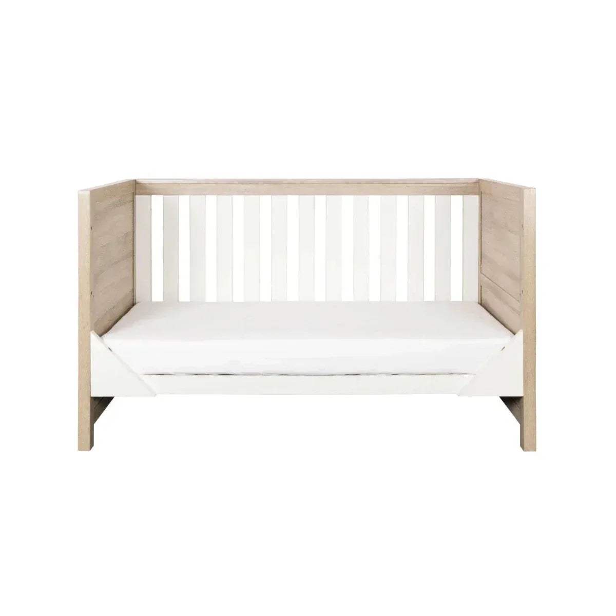 Junior bed with white slatted headboard and light oak side rails, with white mattress