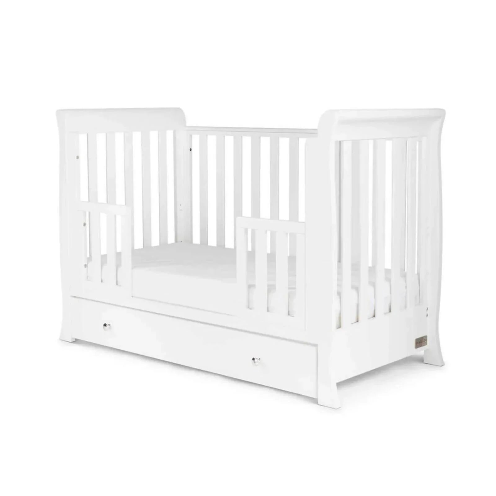 White mini cot bed with front drawer and slatted sides surrounding mattress