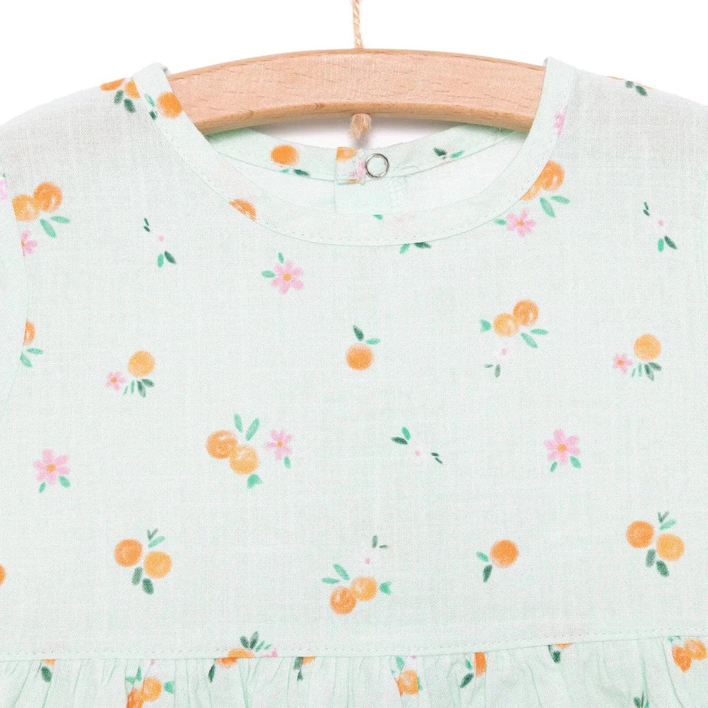 Light blue floral-print bodice with crew neckline and gathered skirt waist