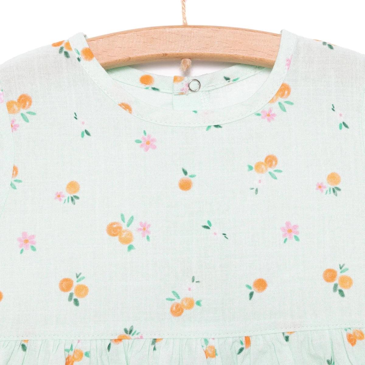 Light blue floral-print bodice with crew neckline and gathered skirt waist