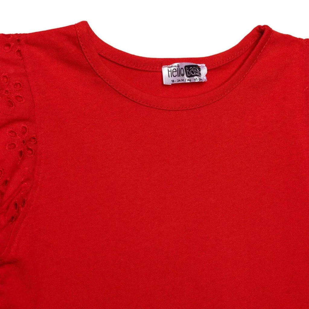 Red baby blouse neckline with Hello Baby label and embroidered sleeve eyelets