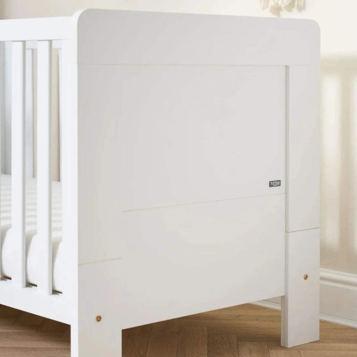 White cot bed side panel and base support with visible hinge hardware