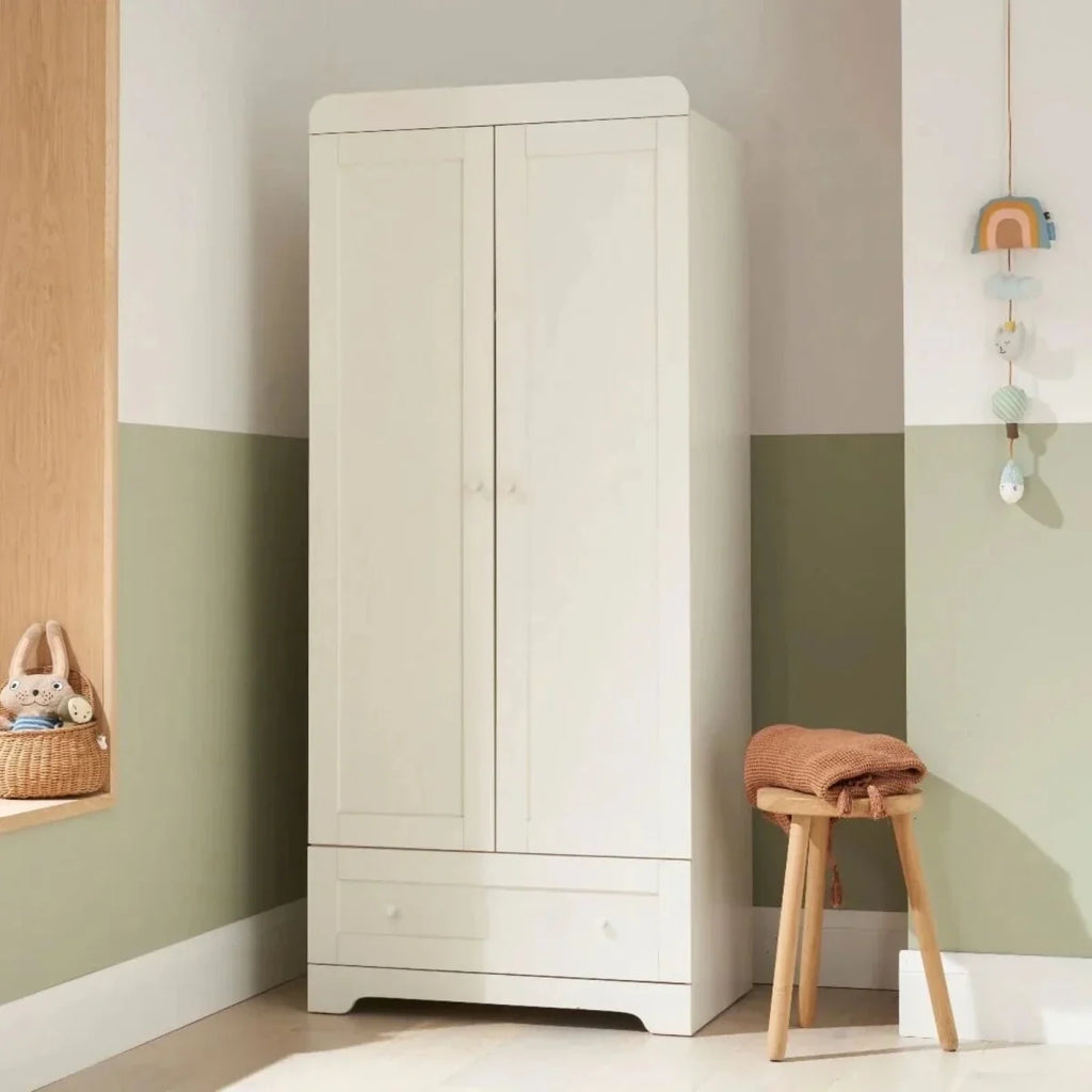 White wardrobe cabinet with two panel doors and bottom drawer, flat base