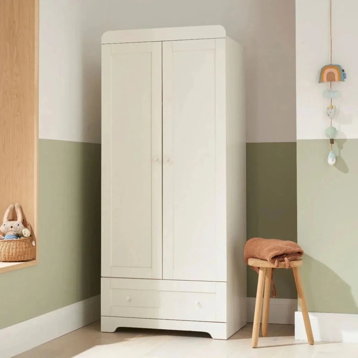 White wardrobe cabinet with two panel doors and bottom drawer, flat base