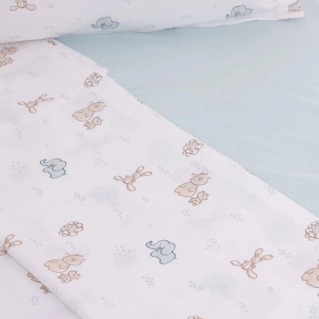Close-up of printed duvet cover fabric with pale blue and beige animal designs