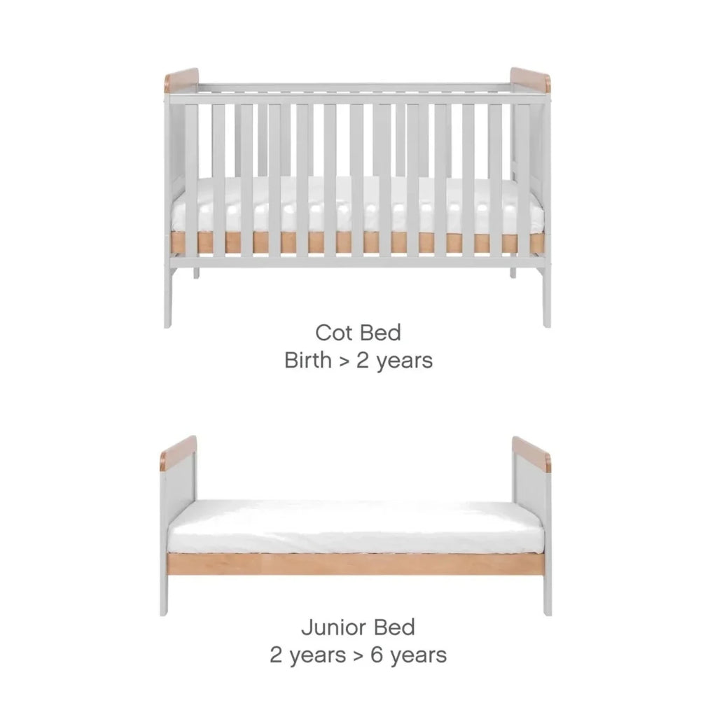 Cot bed showing slatted rails and light wood top panels