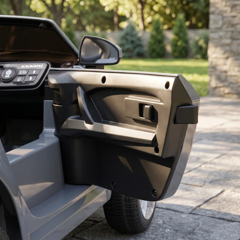 Grey ride-on electric car with open driver door and interior control panel