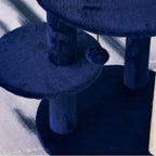 Blue plush round platform with vertical support post on a cat activity tower