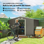 Grey metal storage shed with open double doors and roof vent panel in outdoor yard