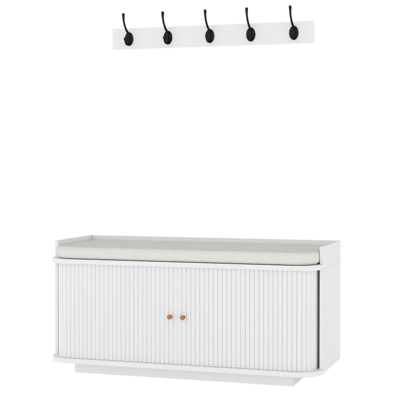 White hallway storage bench with wall-mounted coat hooks and cabinet doors
