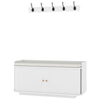 White hallway storage bench with wall-mounted coat hooks and cabinet doors