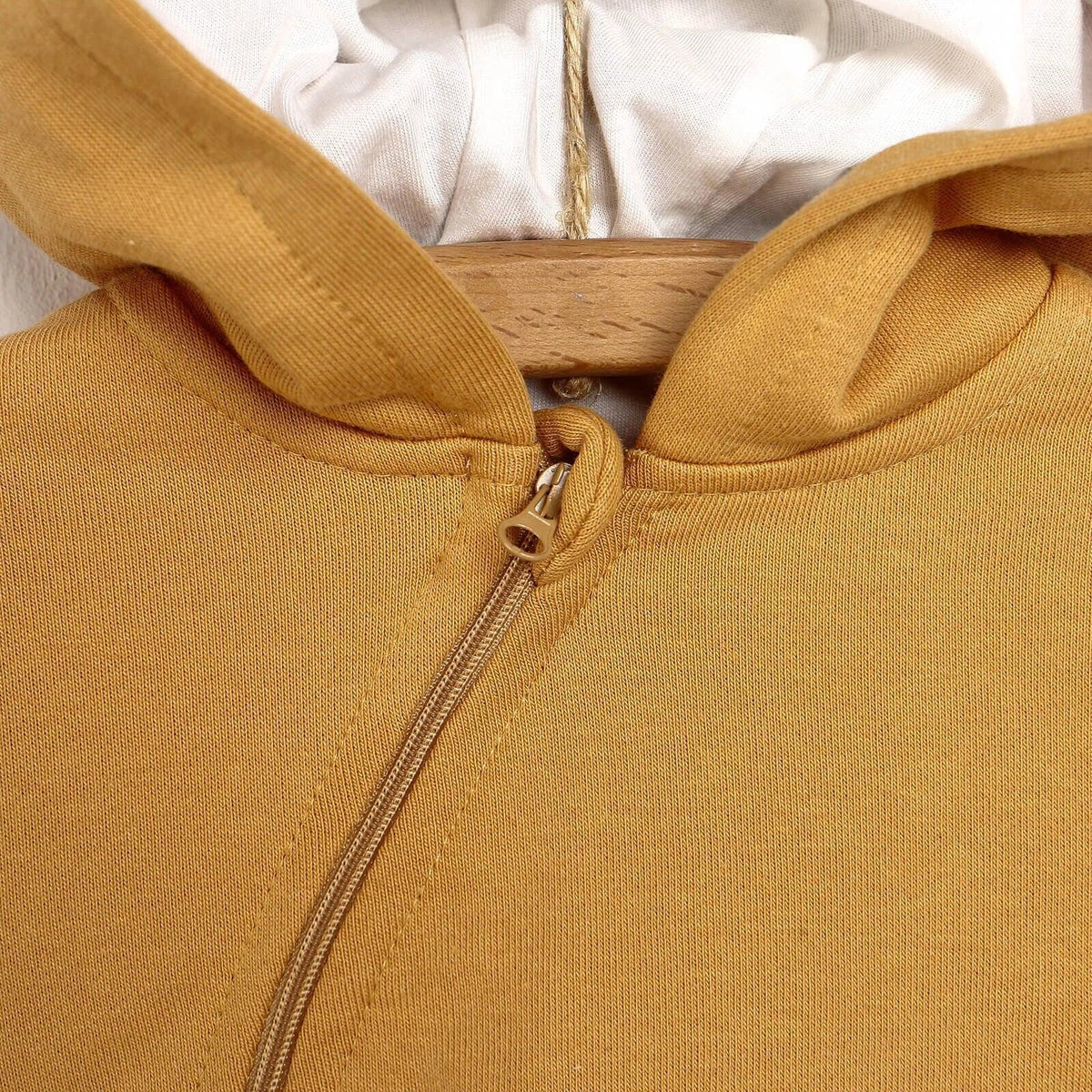 Baby cardigan close-up of cinnamon brown hood and zip front with metal zipper pull