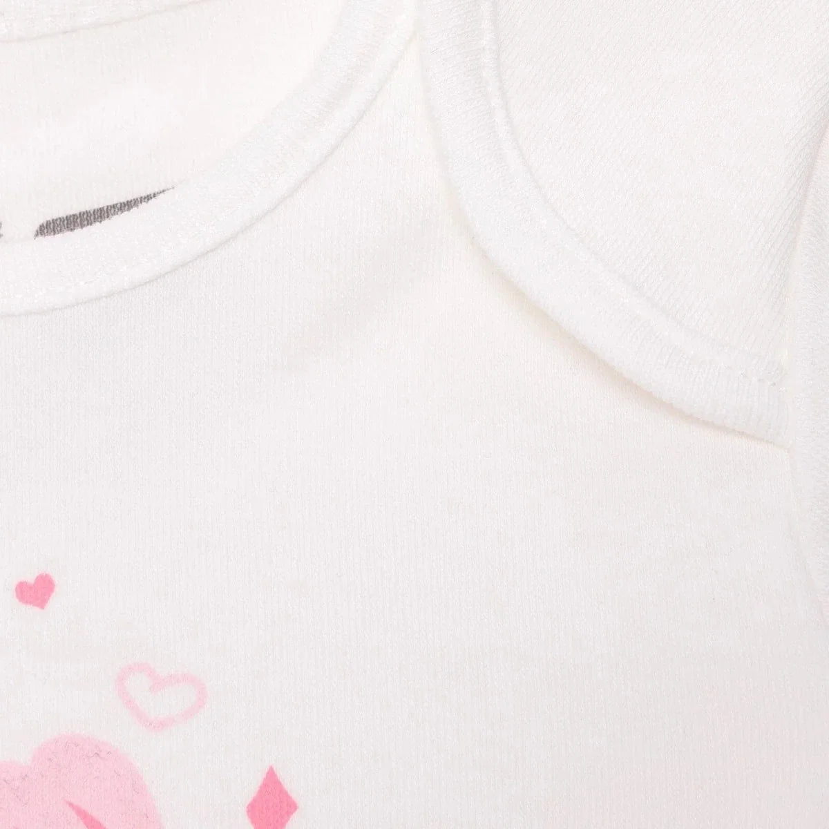 White bodysuit fabric close-up with pink hearts and small tulip graphic