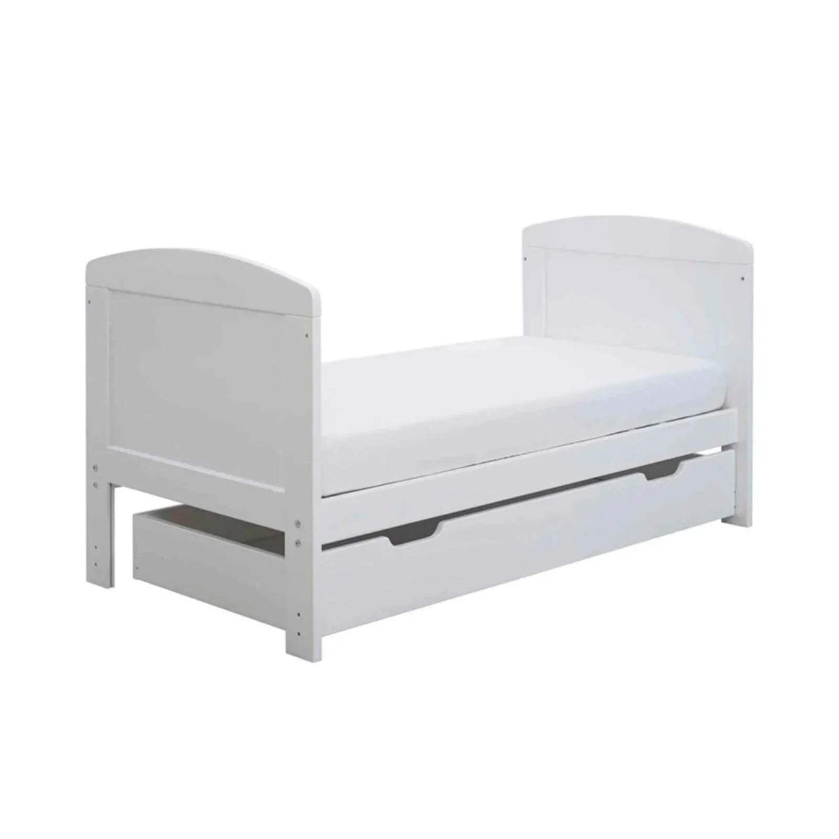 White mini cot bed with mattress and under-drawer panel, three-quarter view