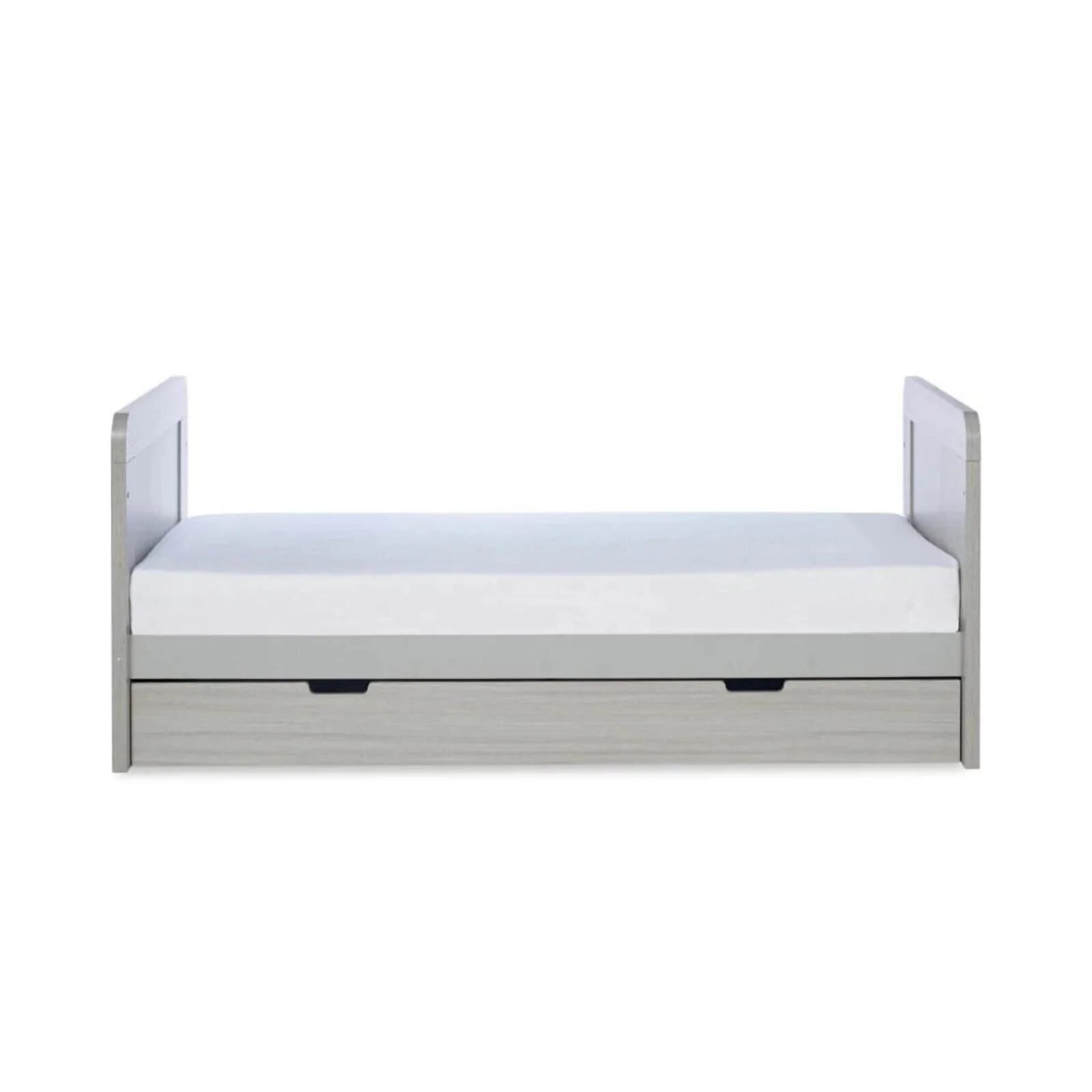 Ash grey cot bed front with white mattress and two drawer handles beneath