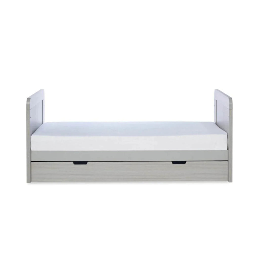 Ash grey cot bed frame with padded-looking insert and under-drawer storage
