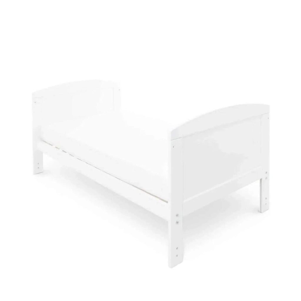 White cot bed with under drawer, angled side view of panel ends and rails