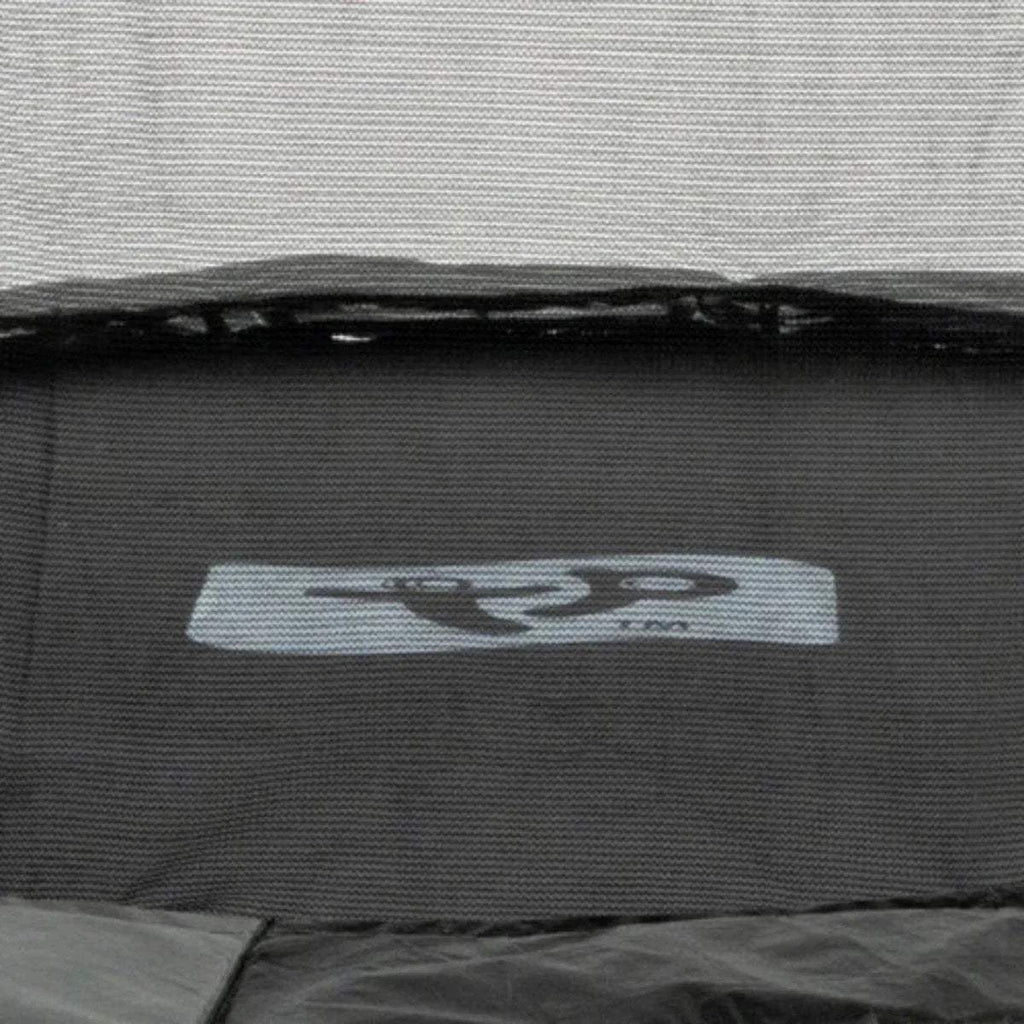 Black trampoline jumping mat close-up with gray label patch near the edge