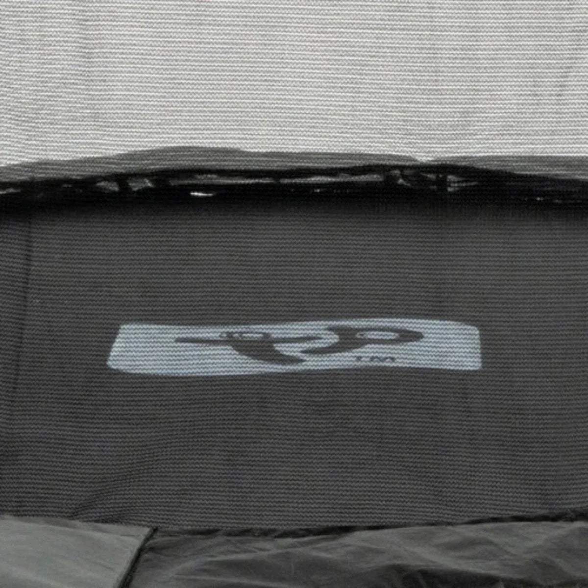 Black trampoline jumping mat close-up with gray label patch near the edge
