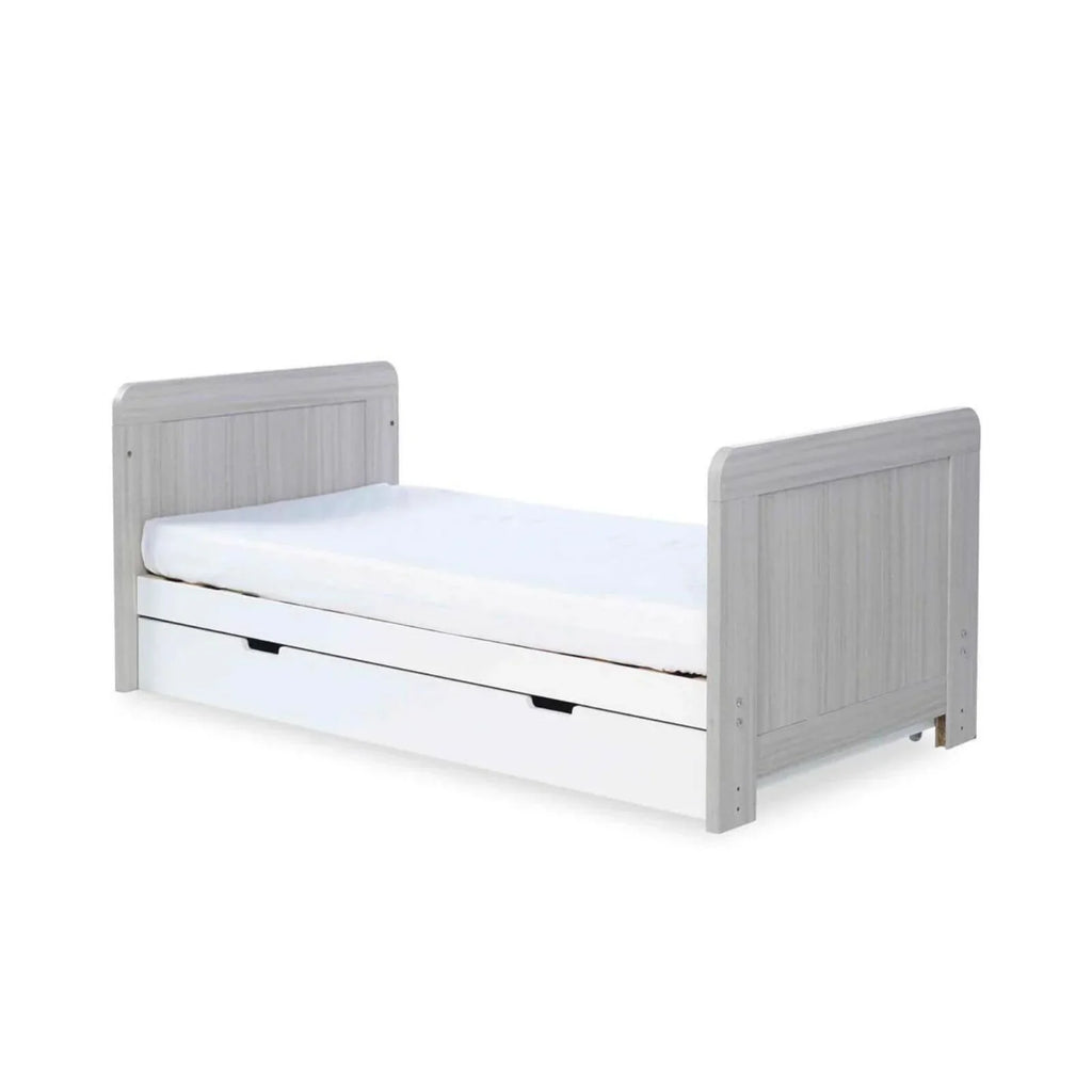 Grey-and-white baby cot with white mattress and solid side panels