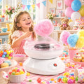 White cotton candy maker with clear bowl and pink cotton candy floss above the plate