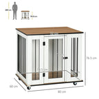 White dog crate end table with dark metal bars and hinged front door, on wheels