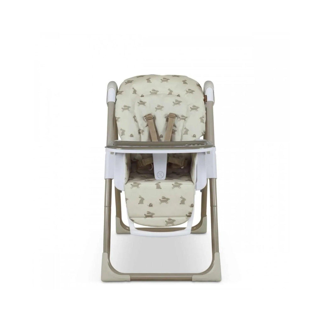 Baby highchair with cream animal print seat, white armrests, and adjustable footrest.